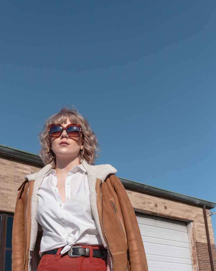 Woman in White Button Up Shirt and Brown Jacket