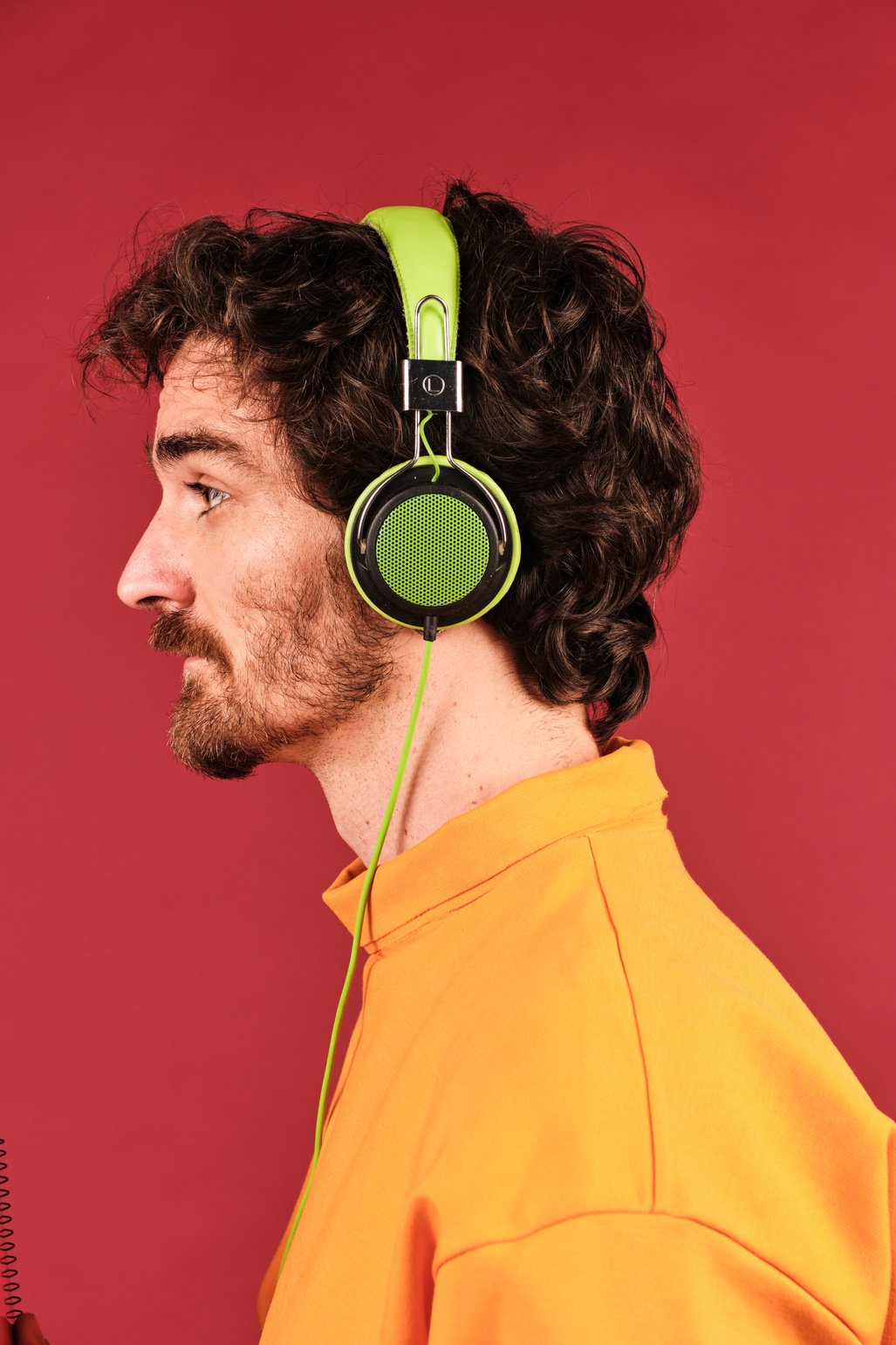 Colorful Headshot of Creative Professional Wearing Green Headphones